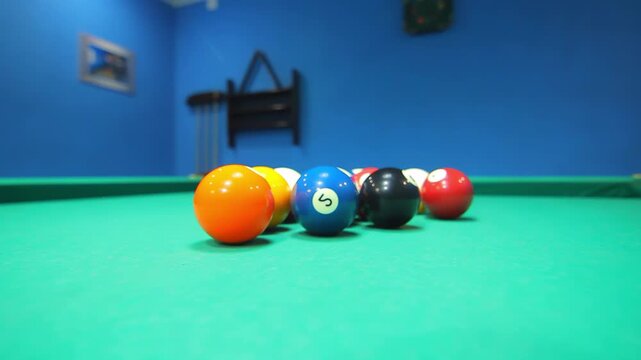 Billiards balls closeup green cloth low angle. Pool game handheld shot leisure.