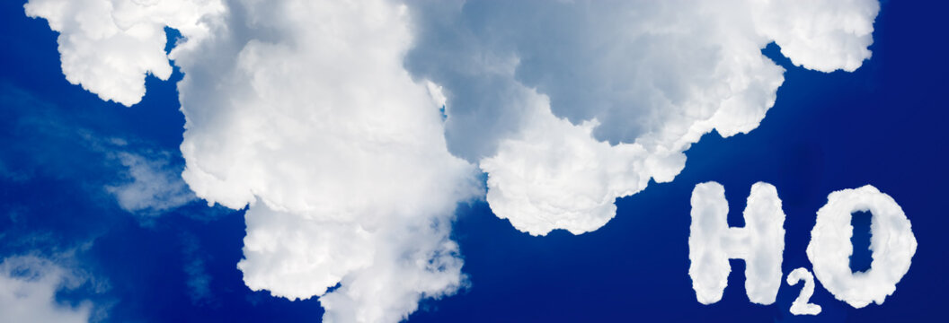White clouds form the shape of water vapor beside the H2O formula in a blue sky