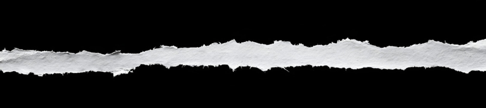 Roughly jagged paper edges detached and set against a black backdrop