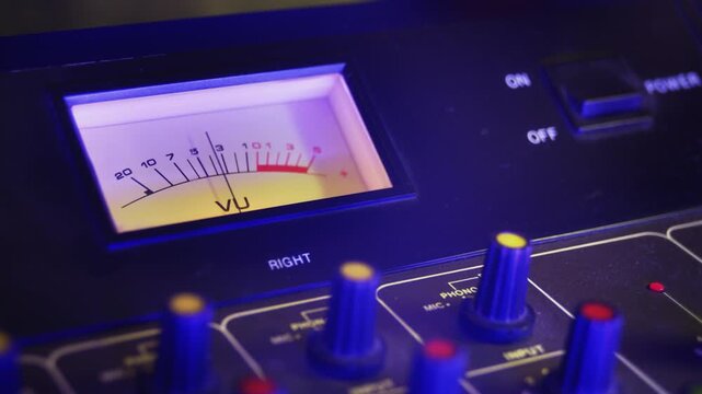 VU meters and mixing channels of an audio console in retro, purple aesthetic. A music production, recording studio and live show broadcasting, concept video loop. Ideal for intros or logos