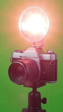 Vintage Retro Film Camera with Classic Flash Bulb Burst on Even Green Screen Background for Compositing