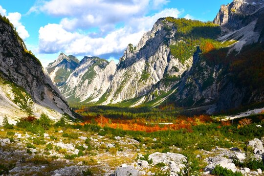 Mountain landscape bellow Slemenova &Scaron;pica in Tamar valley with an orange colored forest foliage in Julian alps, Gorenjska, Slovenia