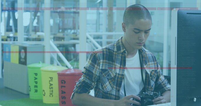 Man in plaid shirt handling DSLR camera at makerspace recycling bins PAPER PLASTIC GLASS