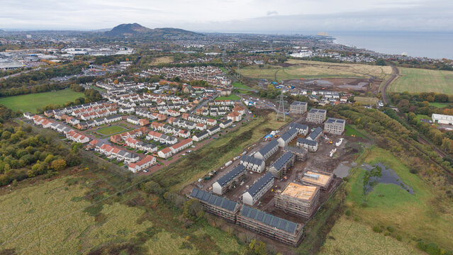 Aerial view of new residential housing development in Newcraighall with Arthur's Seat and Edinburgh skyline in background