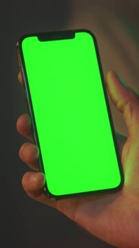 Closeup of hand interacting with screen, Closeup shot capturing rapid thumb swipes on glowing mobile screen