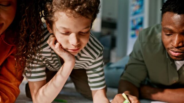 Parents son drawing markers paper living room floor. Close up family art time.