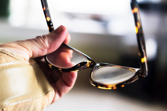 Holding Eyeglasses