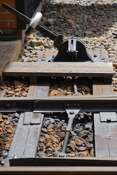 Manual railway switch lever beside railway tracks