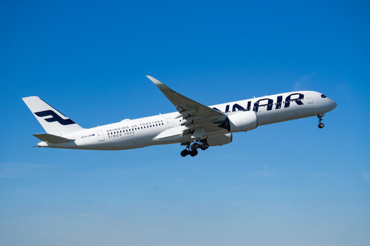 Finnair Airbus A350-900 OH-LWR with Bringing us together since 1923 anniversary slogan climbing from Amsterdam Schiphol Airport on October 4, 2024.