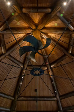 Elegant rustic ceiling fan set against wooden beams at Killarney Mountain Lodge, Ontario, showcasing architecture's blend with nature.