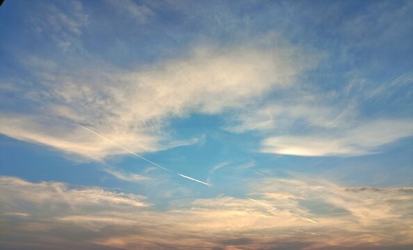 Dramatic sky with golden sunset clouds and bright blue clear space
