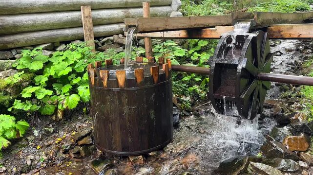 Rustic Wooden Water Wheel and Barrel at a Stream