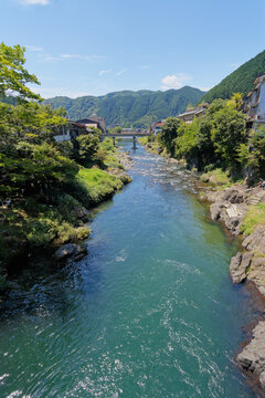 Blue Green River Through a Mountain Town Under a Clear Sky