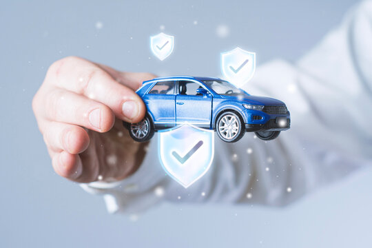 Car insurance concept with a hand holding a blue model SUV surrounded by shield icons and check marks. Vehicle coverage, financial protection and risk management for automotive insurance advertising.