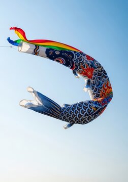 Vibrant cloth carp streamers frozen in a gust of wind under a bright sky, emphasizing sharp details of the artistic patterns and movement, seasonal, artistic, streamer