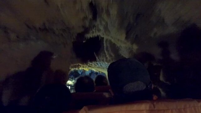 People on a boat trip below stalactites in a dark cave, stalactite cave, Diros Cave, Glyafada Cave, Vlychada Cave, Mani, Peloponnese, Greece
