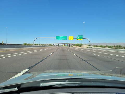 Heading west toward Los Angeles on the multi-lane expanse of the Interstate 10 freeway, the sweeping desert landscape of Phoenix, Arizona, unfolds under a vast open sky.