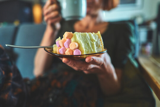 Slice of Frosted Cake with Pink and Orange Marshmallows on a Plate