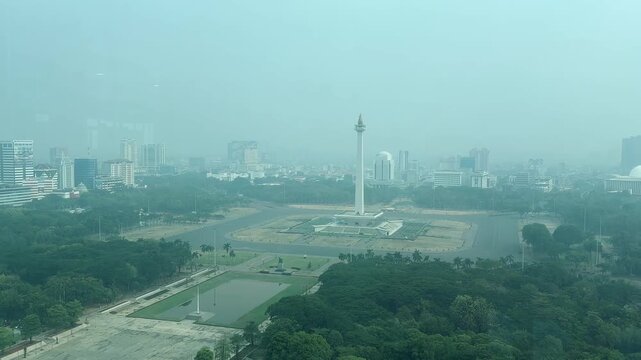 Jakarta, Indonesia, October 21, 2026: An aerial view of the National Monument (Monas) area and its surroundings in Central Jakarta, showing current conditions, including air pollution.
