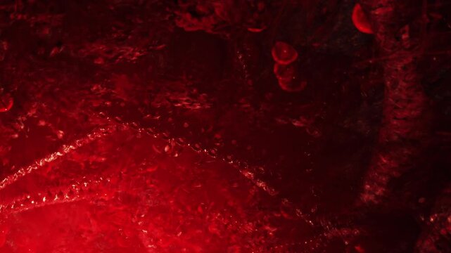 Deep within a captivating space, red light dances over unique textures and shapes, revealing a striking scene filled with intrigue and wonder, sparking curiosity about what lies below.
