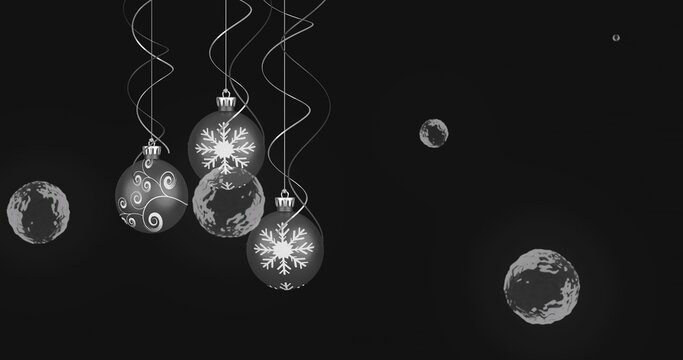 Hanging cluster of baubles occupying left studio backdrop with ribbons and spheres, copy space