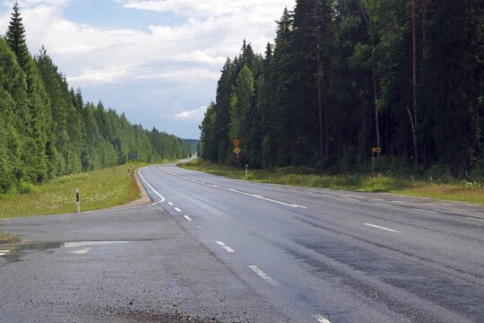 Straight road without traffic, forest left and right, Eastern Finland, Finland
