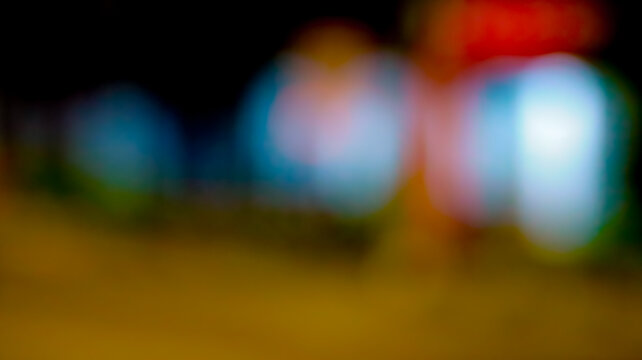 Abstract bokeh night city lights background with colorful blurred glowing circles and defocused street illumination for backdrop