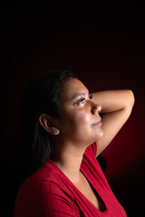 Relaxed Hispanic Woman Posing with Hand Behind Head in Studio © FabianR