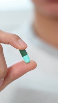 close up woman hand holding a medicine Anti-inflammatory. Stop drug use Taking Medication Caring for the health care medical concept.	