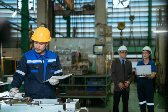 The foreman is checking on operations and holding meetings with his diverse team members in the steel factory.