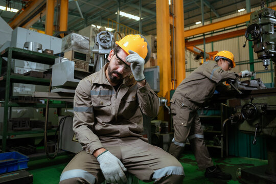 Workers or technicians feeling tired from hot weather overheat in the factory