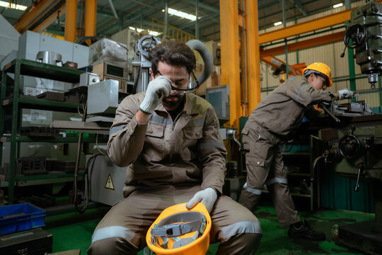 Workers or technicians feeling tired from hot weather overheat in the factory