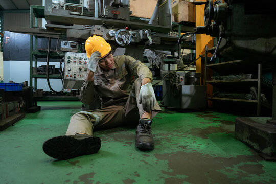 Engineer or Factory worker feeling tired from hard work in a factory, weak, hopeless, burned out, Fired Unemployed Feeling Stressed.