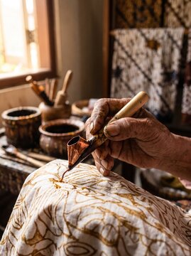 Detailed process of traditional Indonesian batik tulis making in an artisan workshop