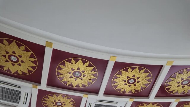 Low Angle Pan of Traditional Ornate Thai Ceiling Patterns