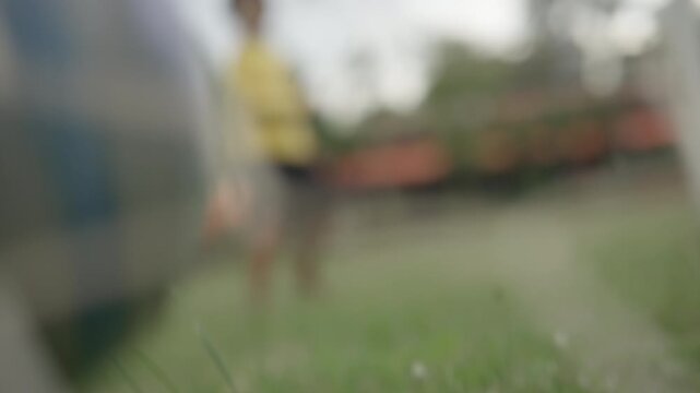 Blurred Soccer Player Standing on Green Grass Field During Outdoor Football Training