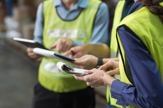 Close up of hands warehouse worker collaborating on logistics management and inventory operations in distribution center