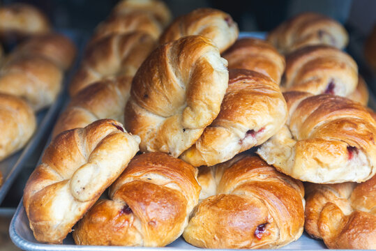 Strawberry Jam Filled Croissants on an Aluminum Tray in a Bakery