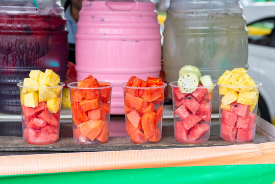 Plastic Containers Filled with Fresh Cut Fruit at a Street Market