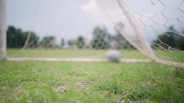 Close Up of Soccer Goal Net on Green Grass Football Field Outdoors