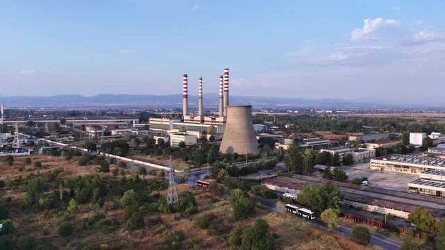 Aerial view of a large thermal power plant with industrial chimneys and cooling tower   