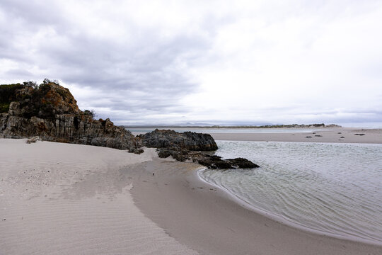 moody late afternoon light falling upon Grotto Lagoon and rocky coastline, Hermanus, South Africa