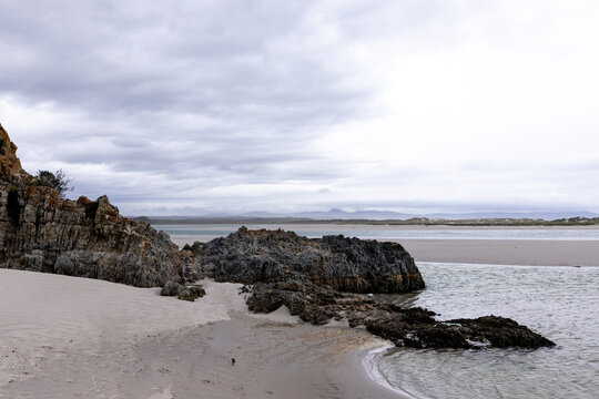 moody late afternoon light falling upon Grotto Lagoon and rocky coastline, Hermanus, South Africa