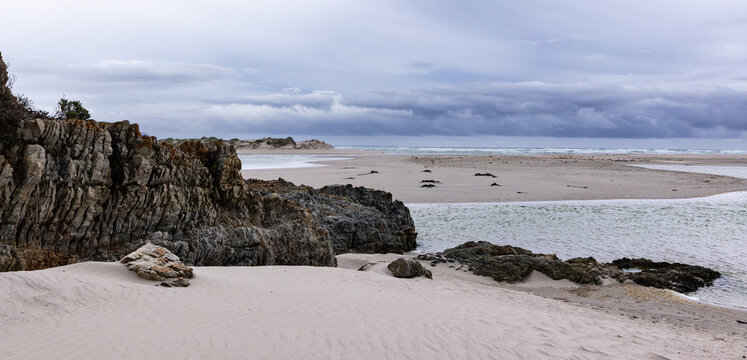 moody late afternoon light falling upon Grotto Lagoon and rocky coastline, Hermanus, South Africa