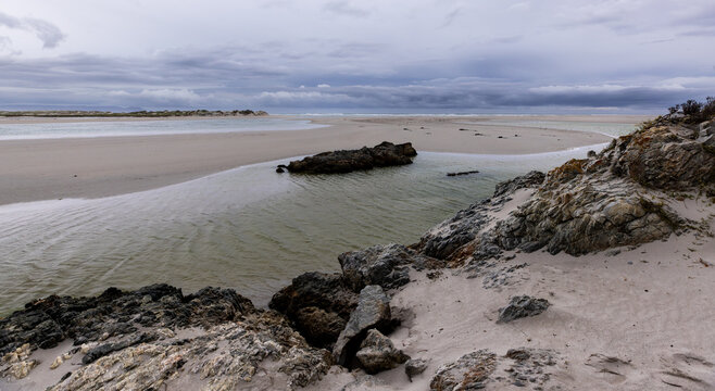 moody late afternoon light falling upon Grotto Lagoon and rocky coastline, Hermanus, South Africa