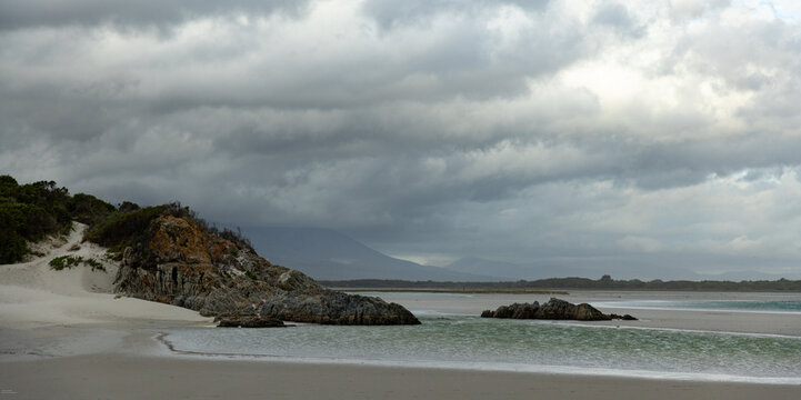 moody late afternoon light falling upon Grotto Lagoon and rocky coastline, Hermanus, South Africa