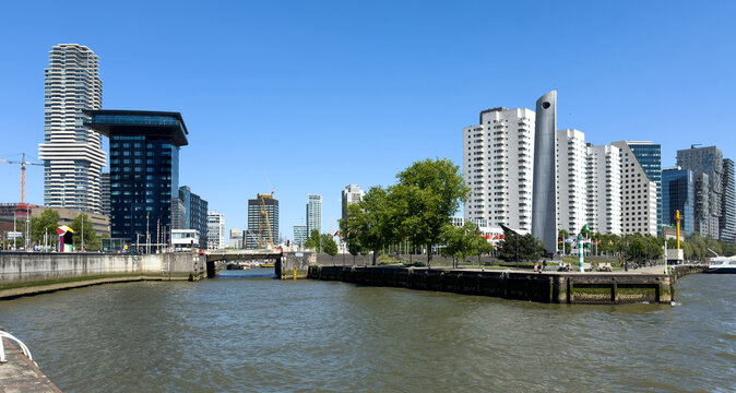 Modern towers behind a quay and harbor bridge in Rotterdam, Netherlands