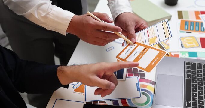 UX UI design and user experience development, featuring creative professionals collaborating on interface layouts, reviewing design prototypes, and refining visual elements to create intuitive.
