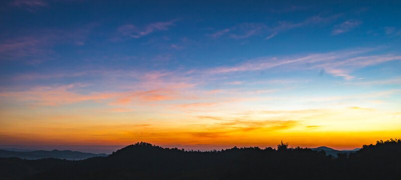 Sunrise paints the sky in soft hues of pink and orange