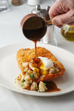 Crispy fried chicken served with poached egg, hollandaise sauce, brunch menu, special occasion dining